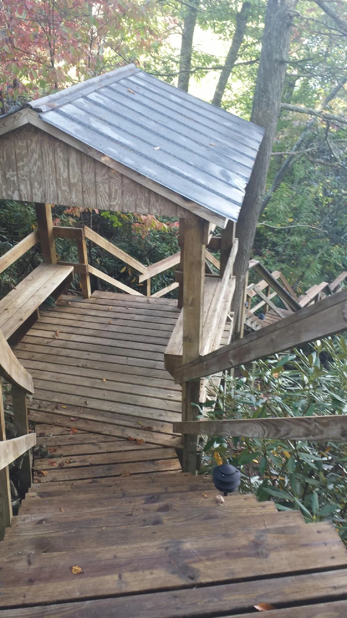 Metal roofed shelter over wooden steps on a wooded walkway — Skylight Repair & Installation work by our crew in South Hadley